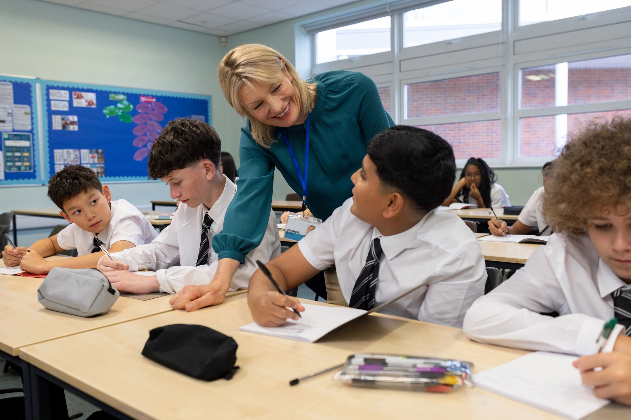 Teacher supporting students in a classroom